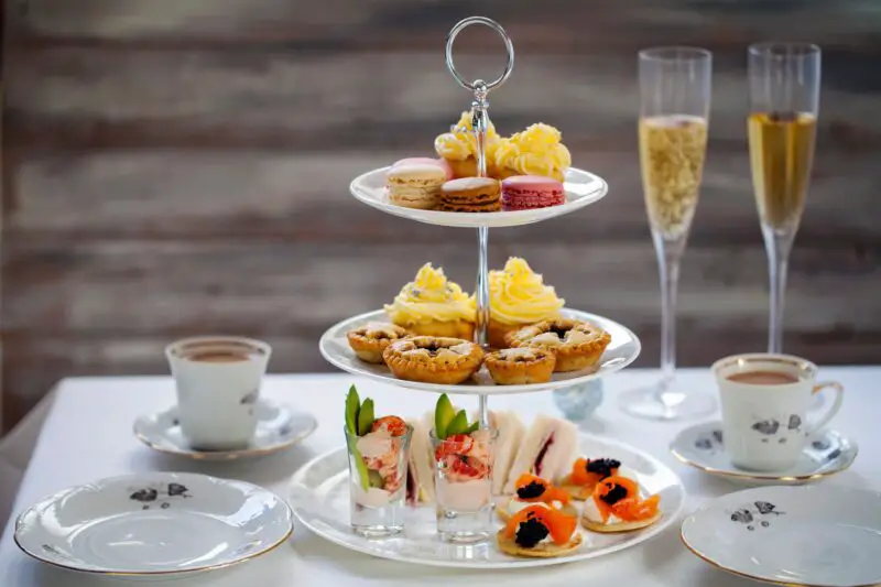 Three-tiered afternoon tea with two glasses of prosecco. Liverpool is one of the best places in the UK to get a boozy afternoon tea