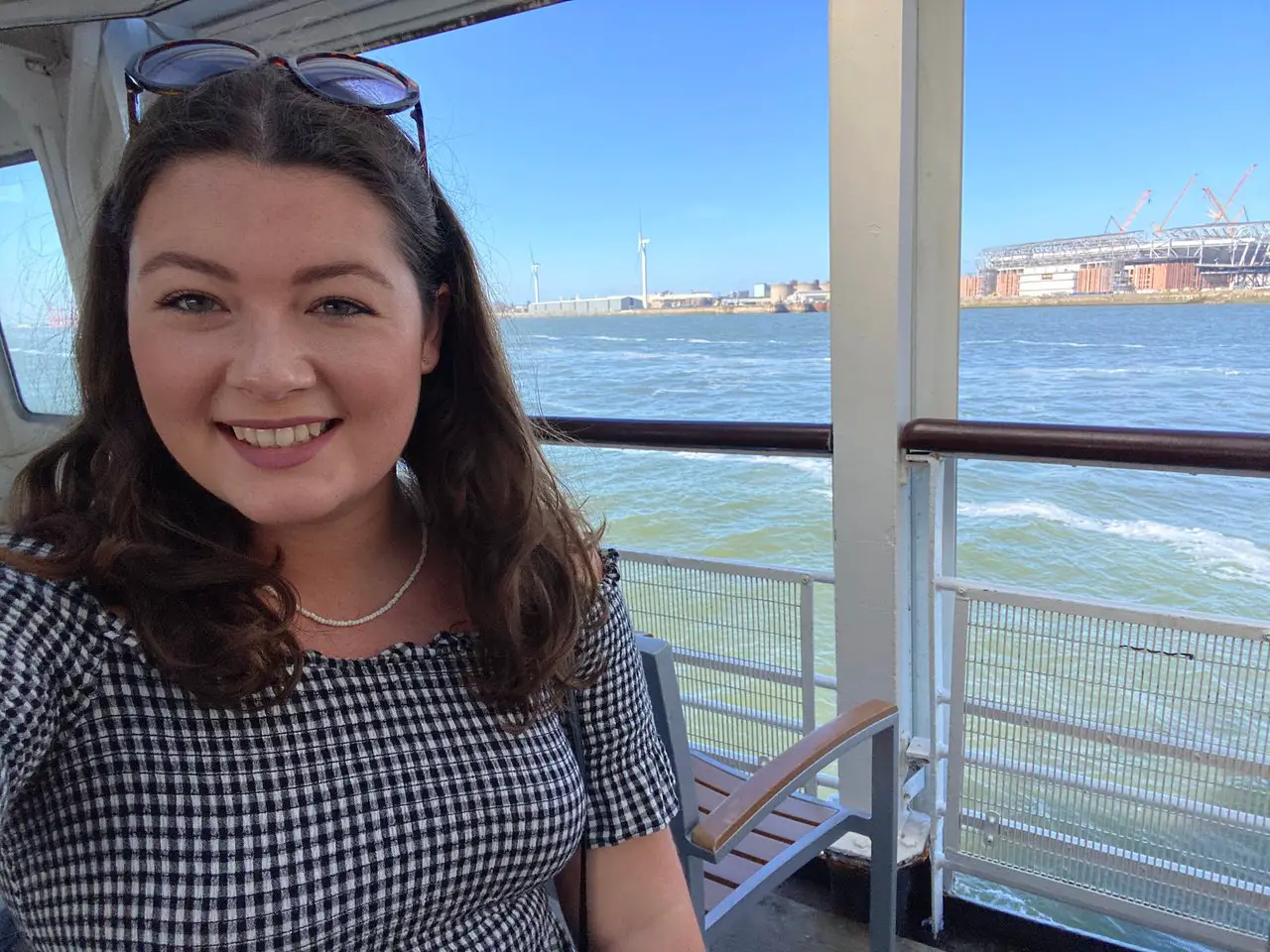 Ella on the Liverpool Mersey ferry with Liverpool in the background