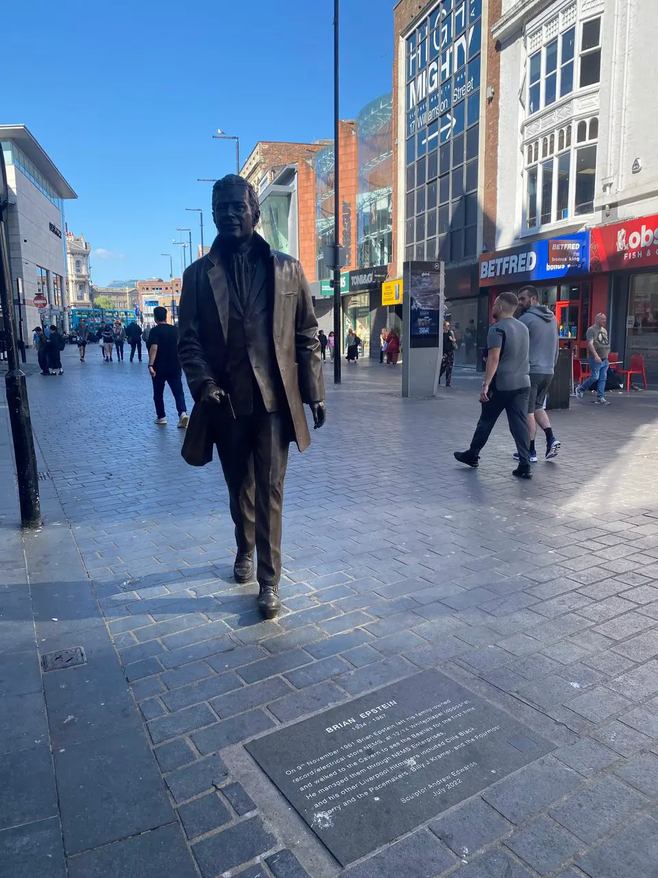 Bronze statue of Beatles manager Brian Epstein on a street in Liverpool England