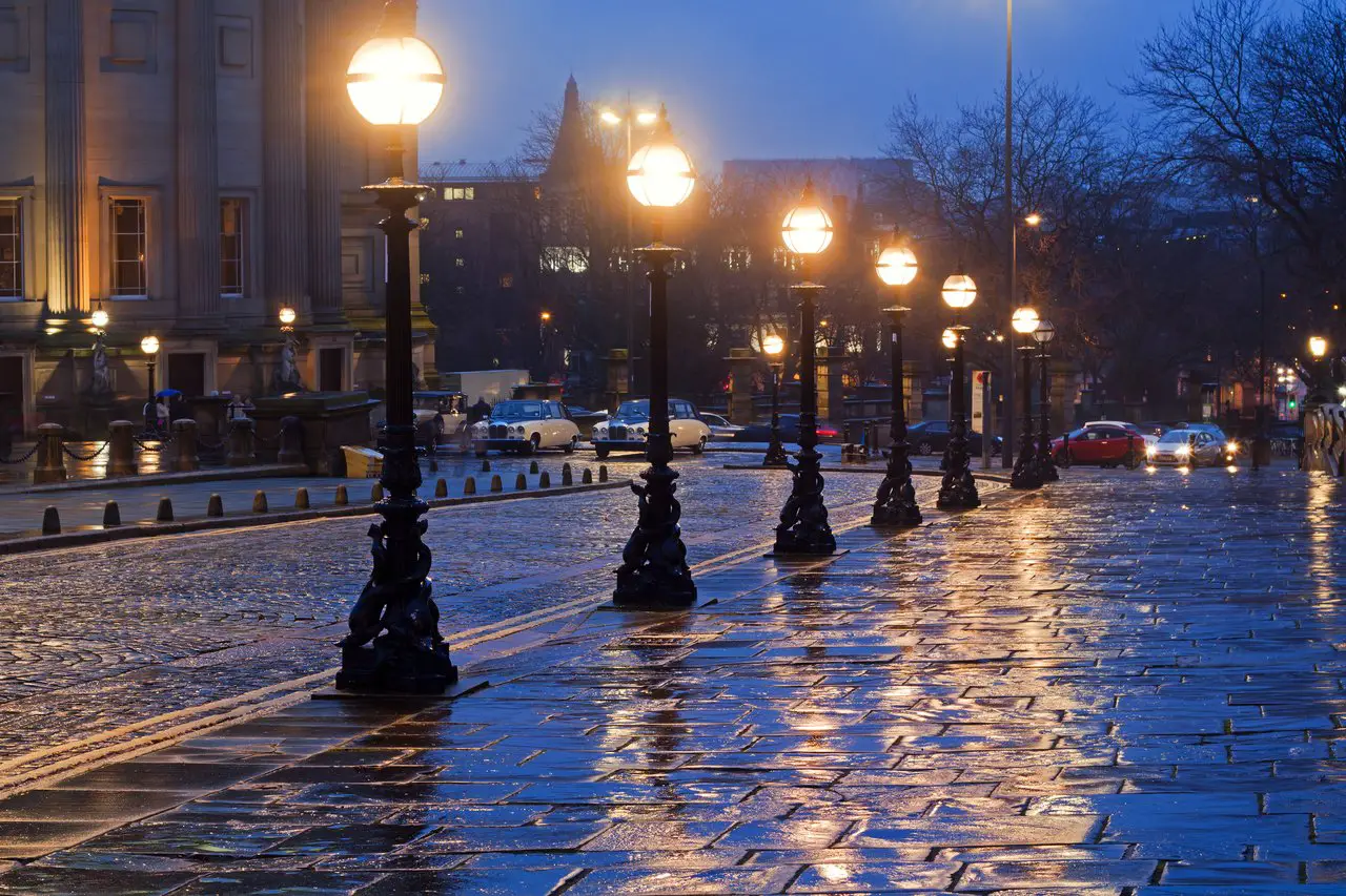 William Brown Street in Liverpool in the rain at twilight, illuminated by old-fashioned streetlights