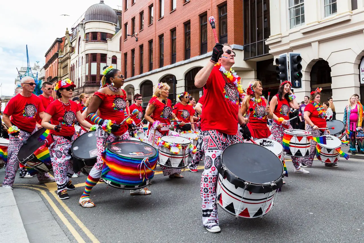 People marching and playing drums during Liverpool pride parade
