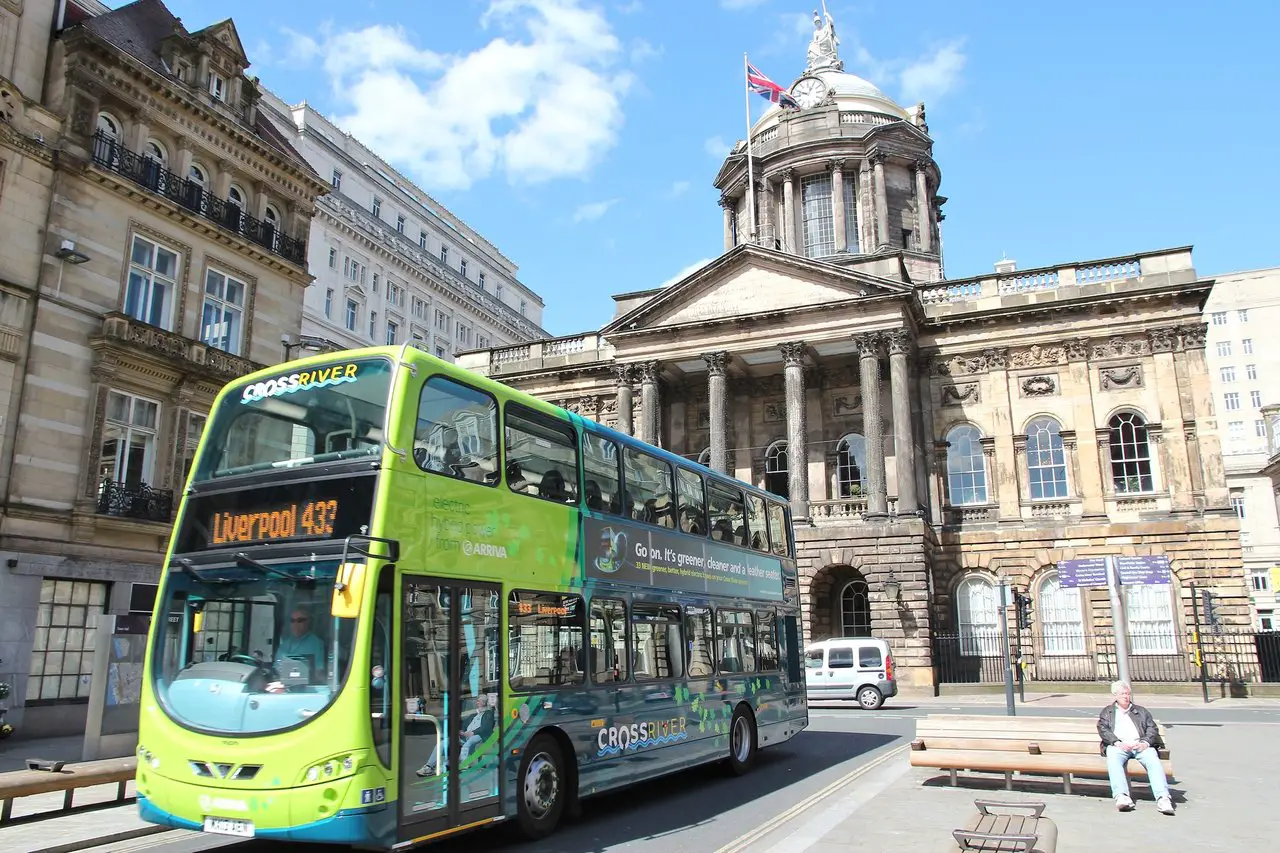 Liverpool bus driving past one of the city's top landmarks.