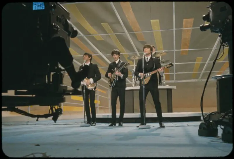 Behind the scenes shot of The Beatles performing at the Ed Sullivan Show in 1962