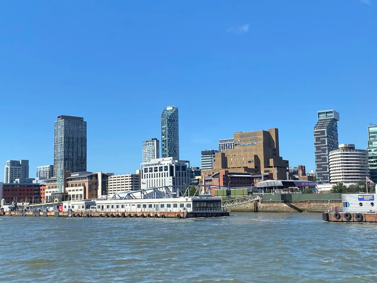 View of Liverpool city skyline from the River Mersey on a sunny day. You'll get great views like this on Liverpool boat trips.