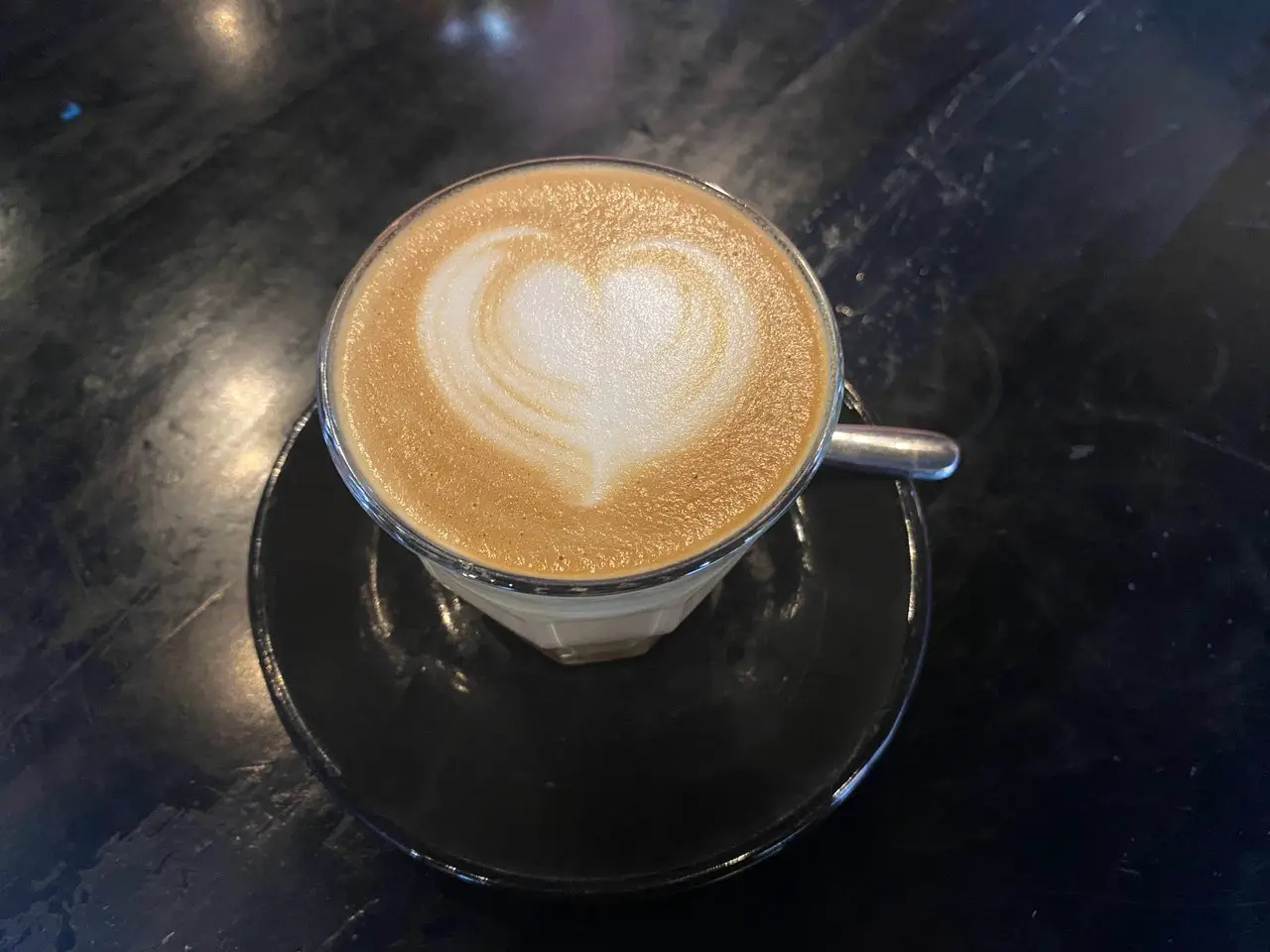 A cup of coffee with latte art showing a heart