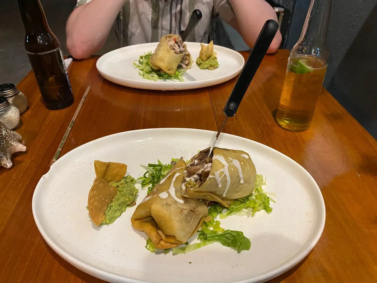 a Chimichanga cut in half with a knife sticking out of the top, eaten at a Mexican restaurant in Liverpool.
